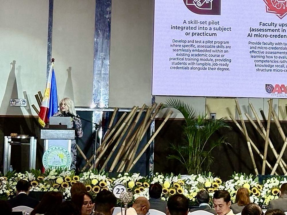 Dr. Ingrid Ursua addressing PACUCOA member institutions from the lectern